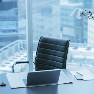 High Angle Shot of a Working Desk of an Successful Person in Office with Cityscape Window View.